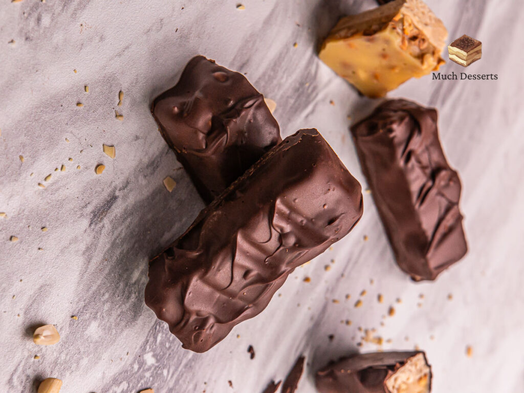 Craving a homemade Snickers bar? Our easy recipe delivers chewy nougat, crunchy peanuts, and caramel, all topped with semi-sweet chocolate.